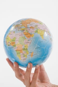 Close_up of a personŽs hand holding a globe