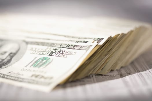 Close_up of US paper currency on a financial newspaper