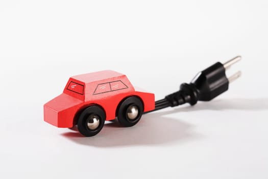 Close_up of a toy electric car with an electric plug