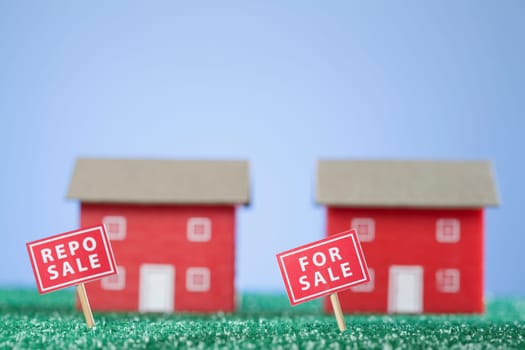 For Sale sign board in front of model homes