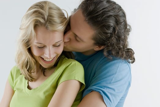 Close_up of a young man kissing a young woman