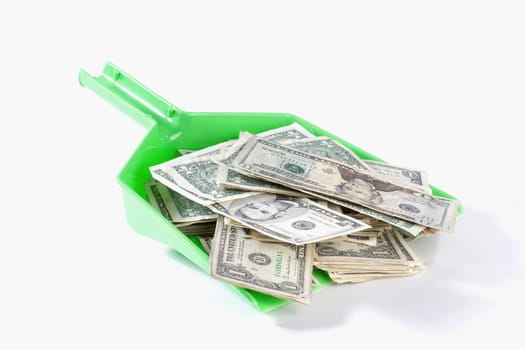 Close_up of US dollar bills in a dustpan