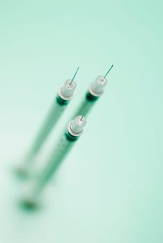 High angle view of three syringes