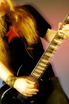 Mid section view of a musician playing the electric guitar