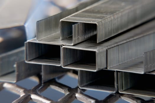 Close-up of a stack of staples on a metal grill