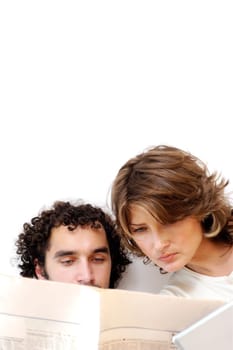 Close-up of a young couple reading a newspaper