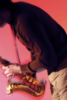 Mid section view of a musician playing the saxophone
