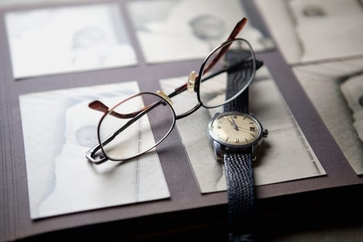 Close-up of a wristwatch and a pair of eyeglasses