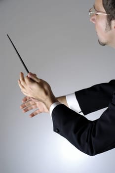 Close-up of a conductor holding a baton