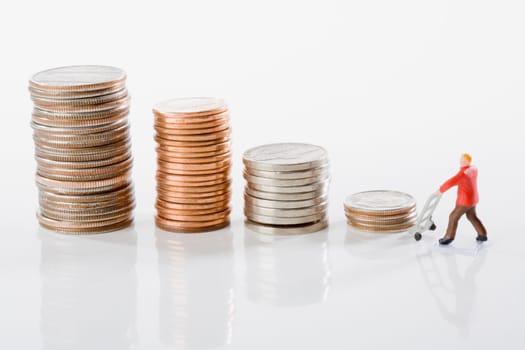 Figurine of a manual worker with stacks of coins
