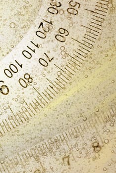 Close-up of a protractor and a ruler in water