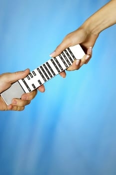 Close-up of a man and a womanŽs hands holding a remote control