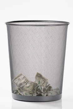Close_up of US dollar bills in a garbage bin