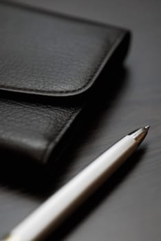 Close-up of a pen and a wallet