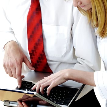 Businessman and a businesswoman using a laptop