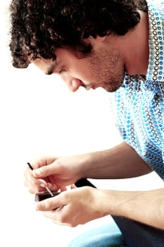 Side profile of a young man operating a personal data assistant