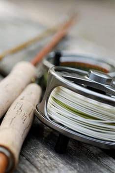 Close-up of a fishing reel and two fishing rods