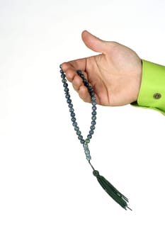 Close-up of a manŽs hand holding prayer beads