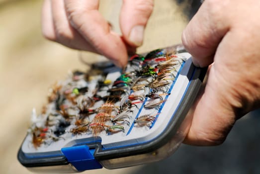 Close-up of a personŽs hand holding a fly box