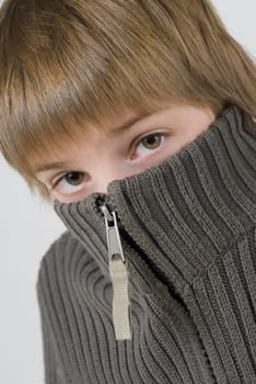 Portrait of a boy hiding his face