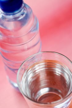 High angle view of a glass of water with a water bottle