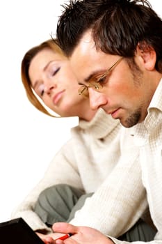 Side profile of a businessman working with a businesswoman napping beside him
