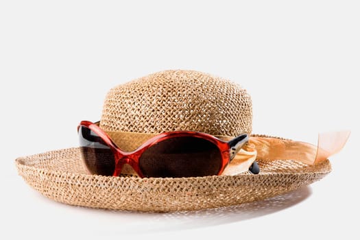 Close-up of a straw hat with sunglasses