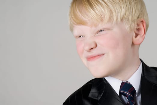Close_up of a boy smirking