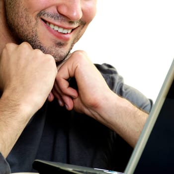 Close-up of a young man in front of a laptop
