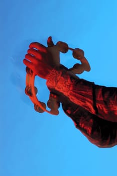 Close-up of a musicianŽs hands playing the tambourine