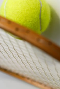 Close-up of a tennis ball with a tennis racket