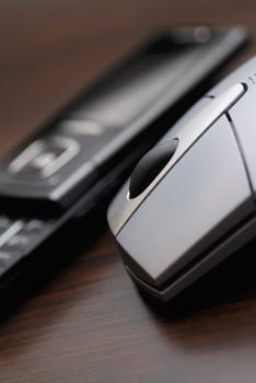 Close-up of a computer mouse with a mobile phone