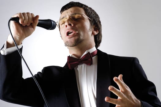 Close-up of a young man singing into a microphone