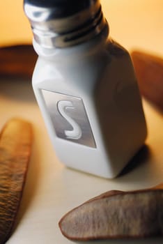 Close-up of a salt shaker with dry beans