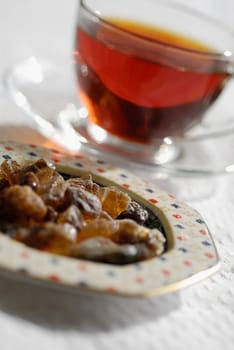 Close-up of a cup of black tea with snacks