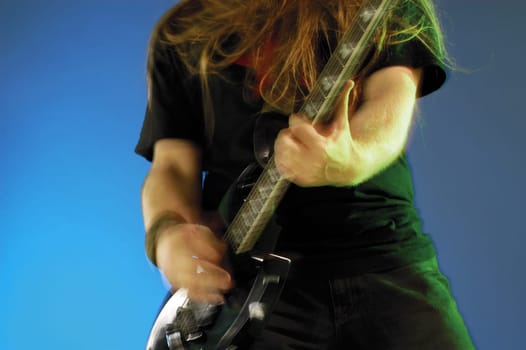 Mid section view of a musician playing the electric guitar
