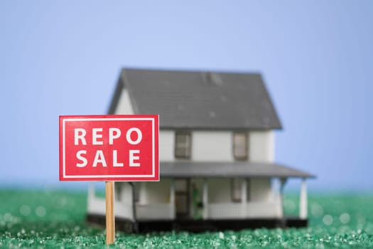 Repo sale sign board in front of a model home