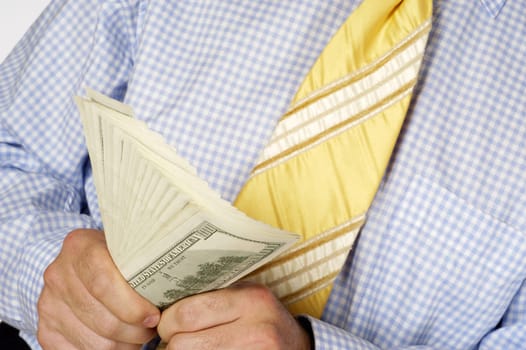 Mid section view of a businessman holding paper currency