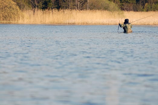 Rear view of a man fishing in the river