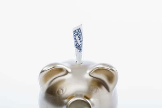 Paper currency sticking out of a piggy bank