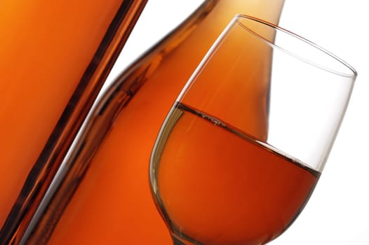 Close-up of a glass of wine with two wine bottles