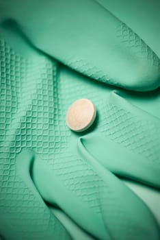 Close_up of a pill on a glove