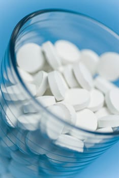 Close_up of pills in a glass