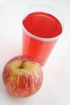 High angle view of an apple with a glass of juice