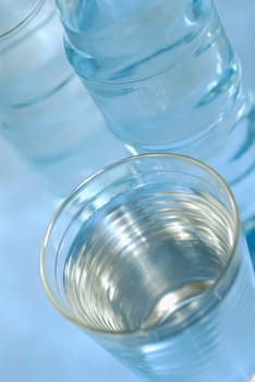 Close-up of a glass of water with two water bottles