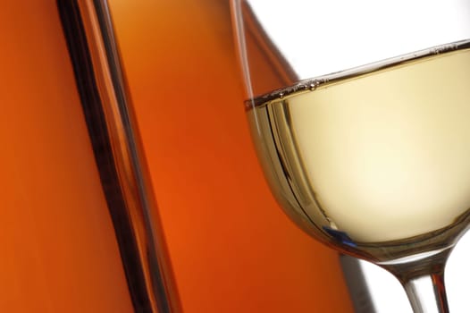 Close-up of a glass of wine with two wine bottles