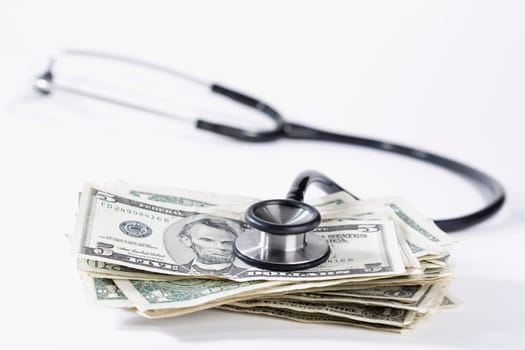 Close_up of stethoscope on US dollar bills
