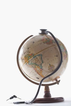 Close_up of a stethoscope on a globe
