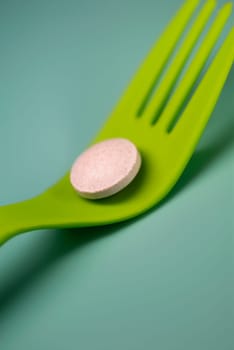 Close_up of a pill on a fork