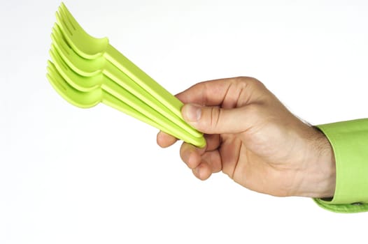 Close-up of a personŽs hand holding four plastic forks